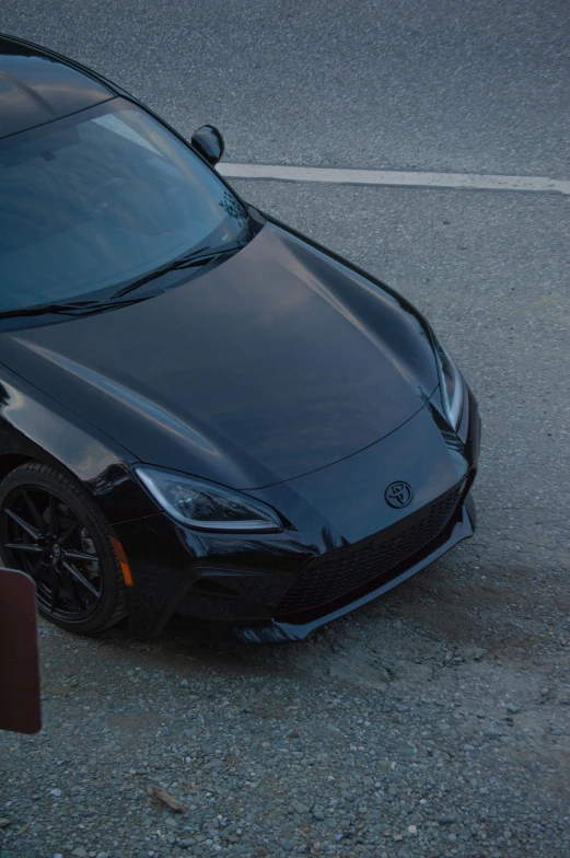 a black sports car with tinted windshield parked in the street