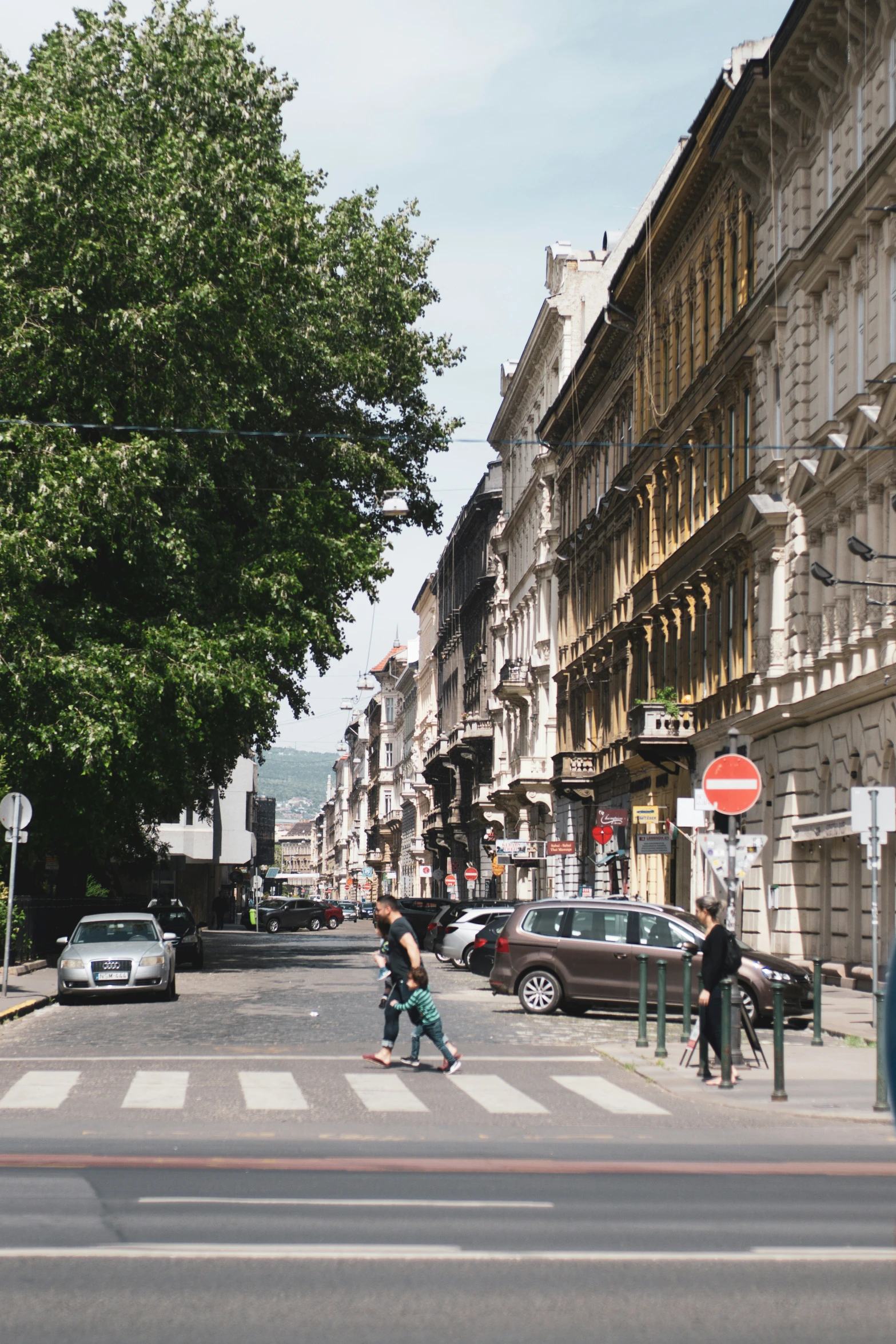 two people crossing the street on skateboards