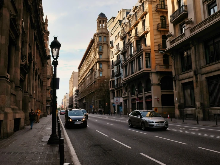 a street filled with tall buildings next to traffic