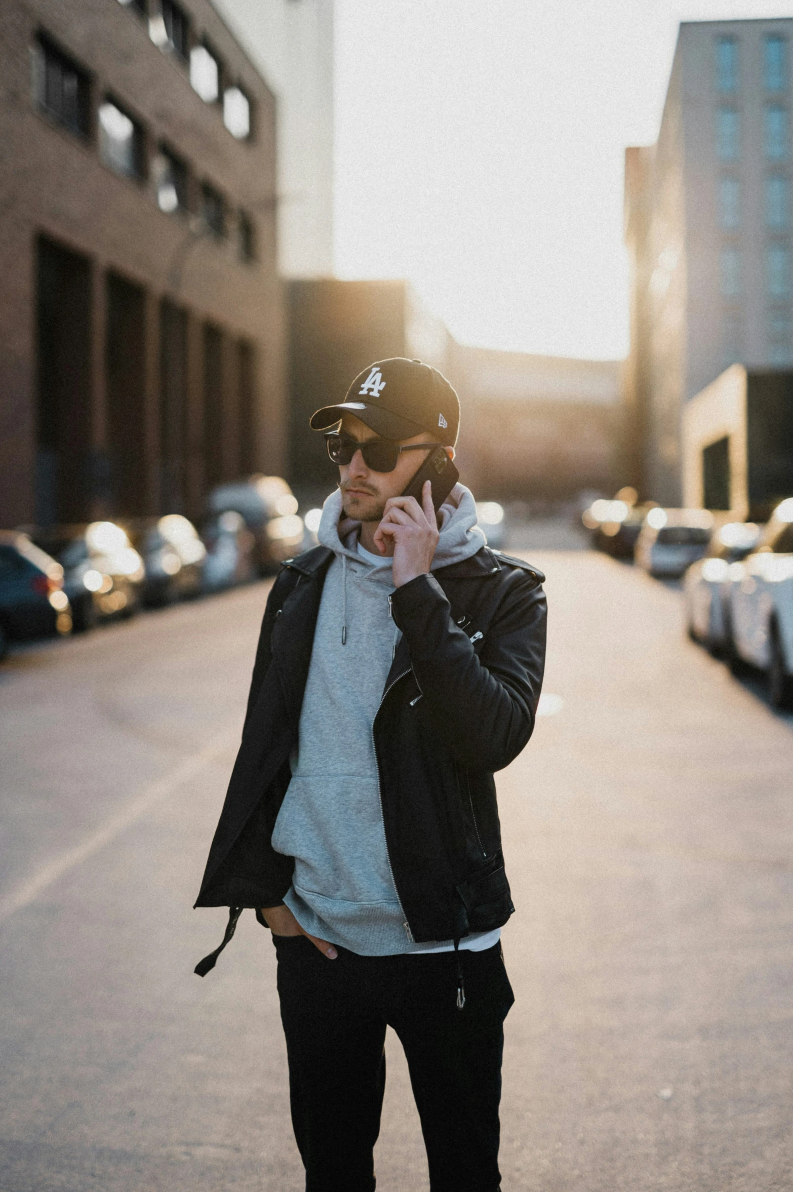 a man standing in the middle of an alley while talking on a cell phone