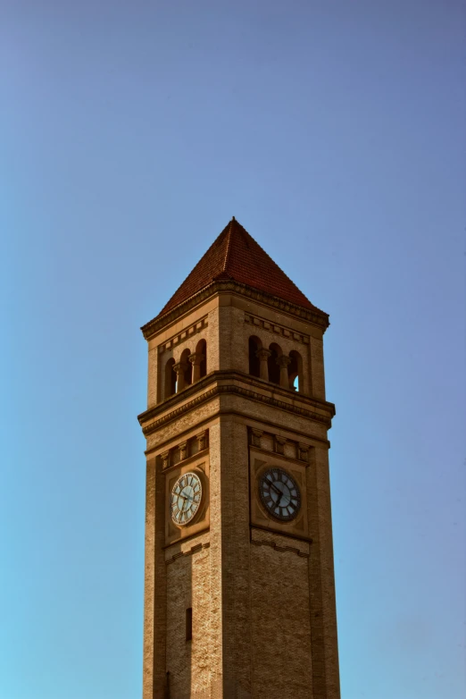 this is a clock tower with a light brown building