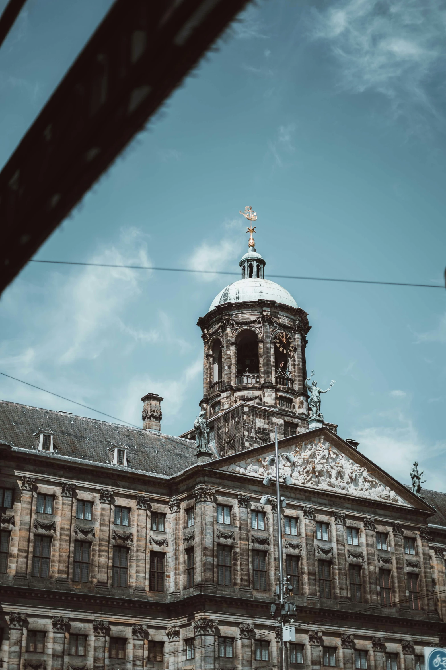 a big building with a clock tower that is standing on a pole