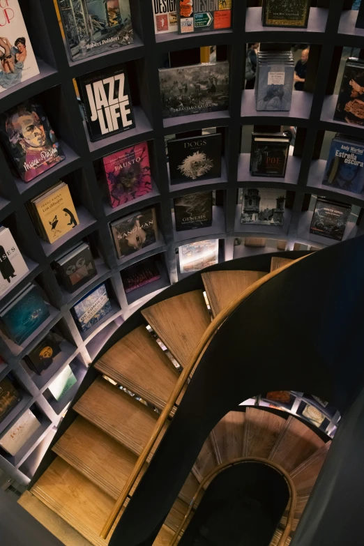 there is a stairway with books on the shelves