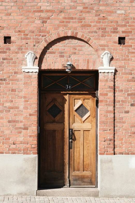 an arched doorway sits in front of a brick building