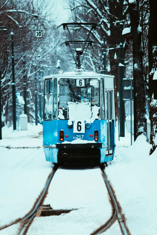 a city cable car moving through the snow