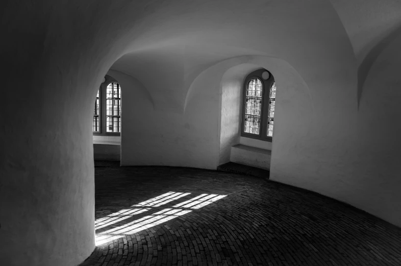 light through windows and arches in a white building