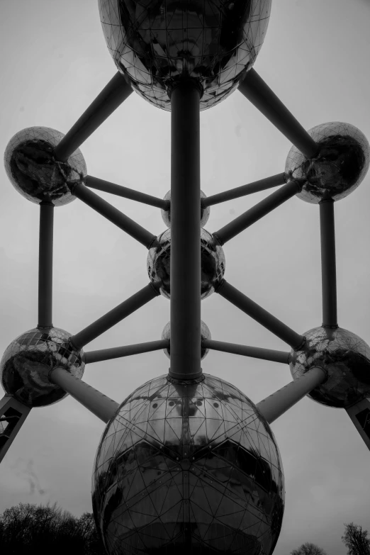 an abstractly arranged sculpture sitting under a cloudy sky