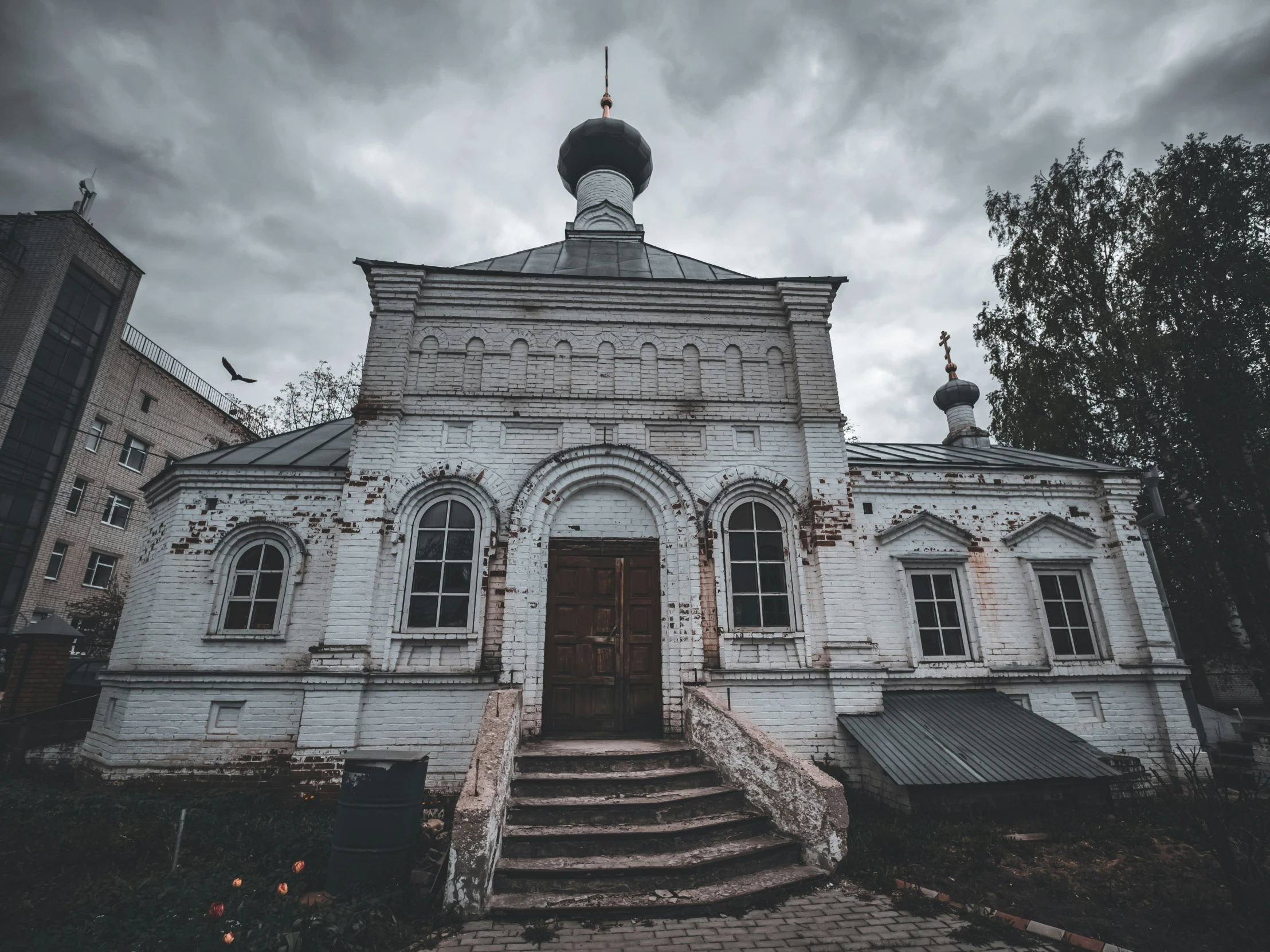 a white church with stairs leading up to it