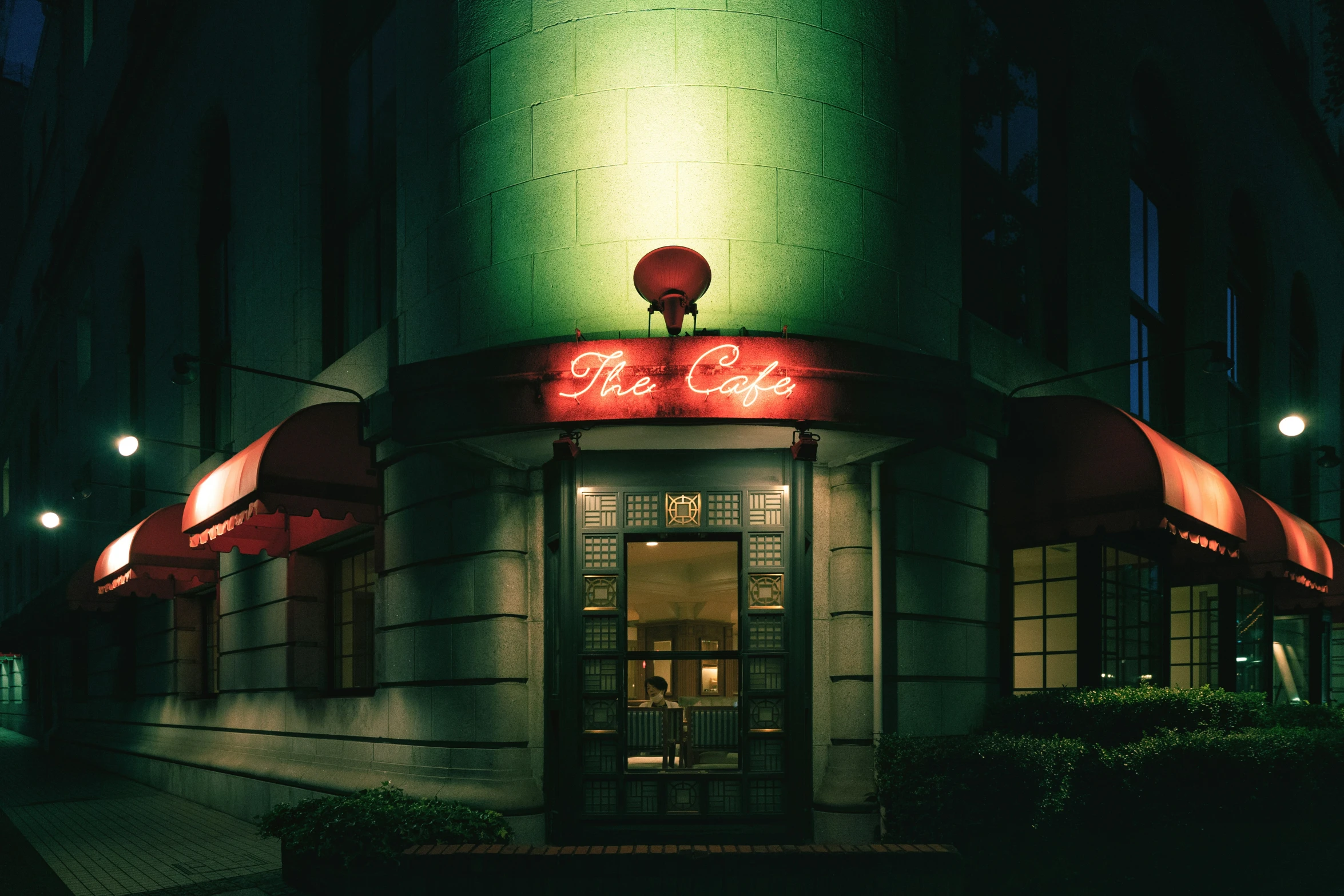 a lit up entrance of a building at night