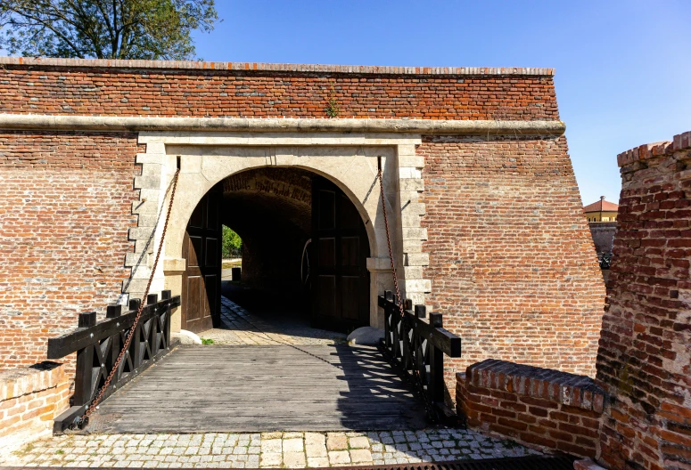 the entrance to a brick building, with gates in the middle