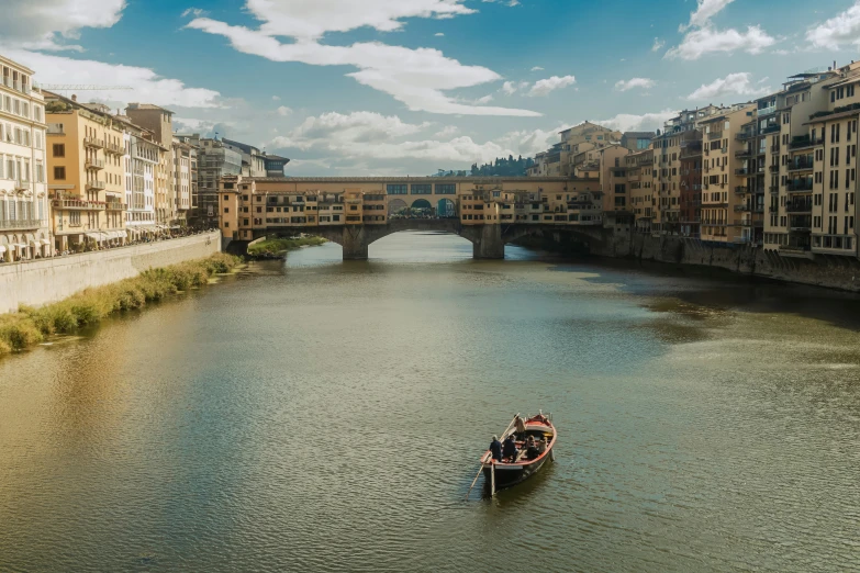 the man is rowing a boat down the river