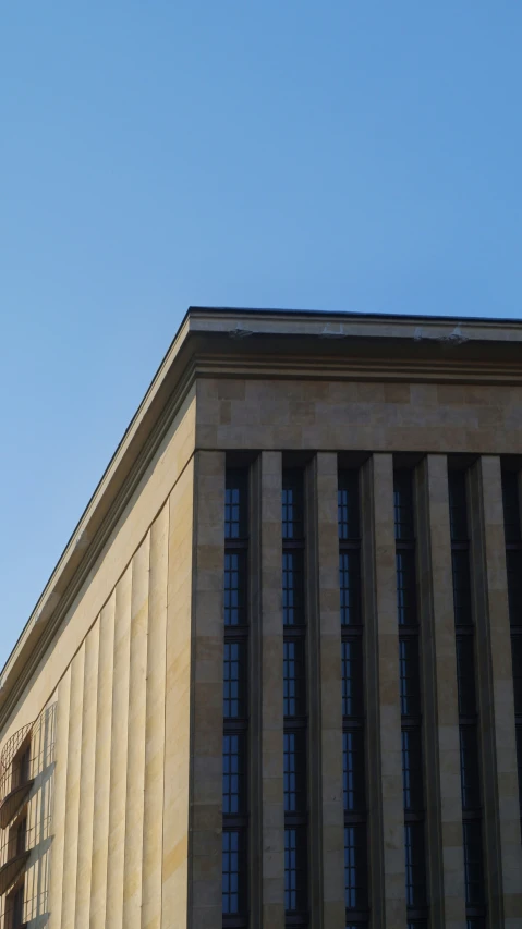 a building with two tall windows and a traffic light