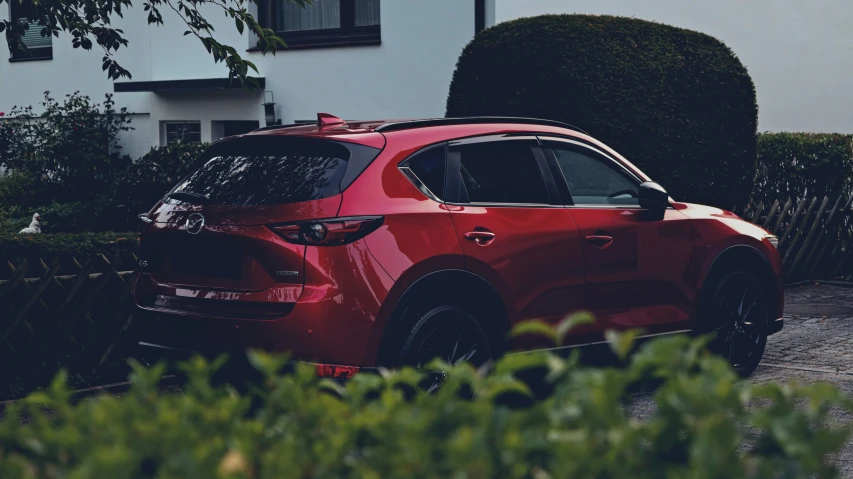 a small red car parked near a house