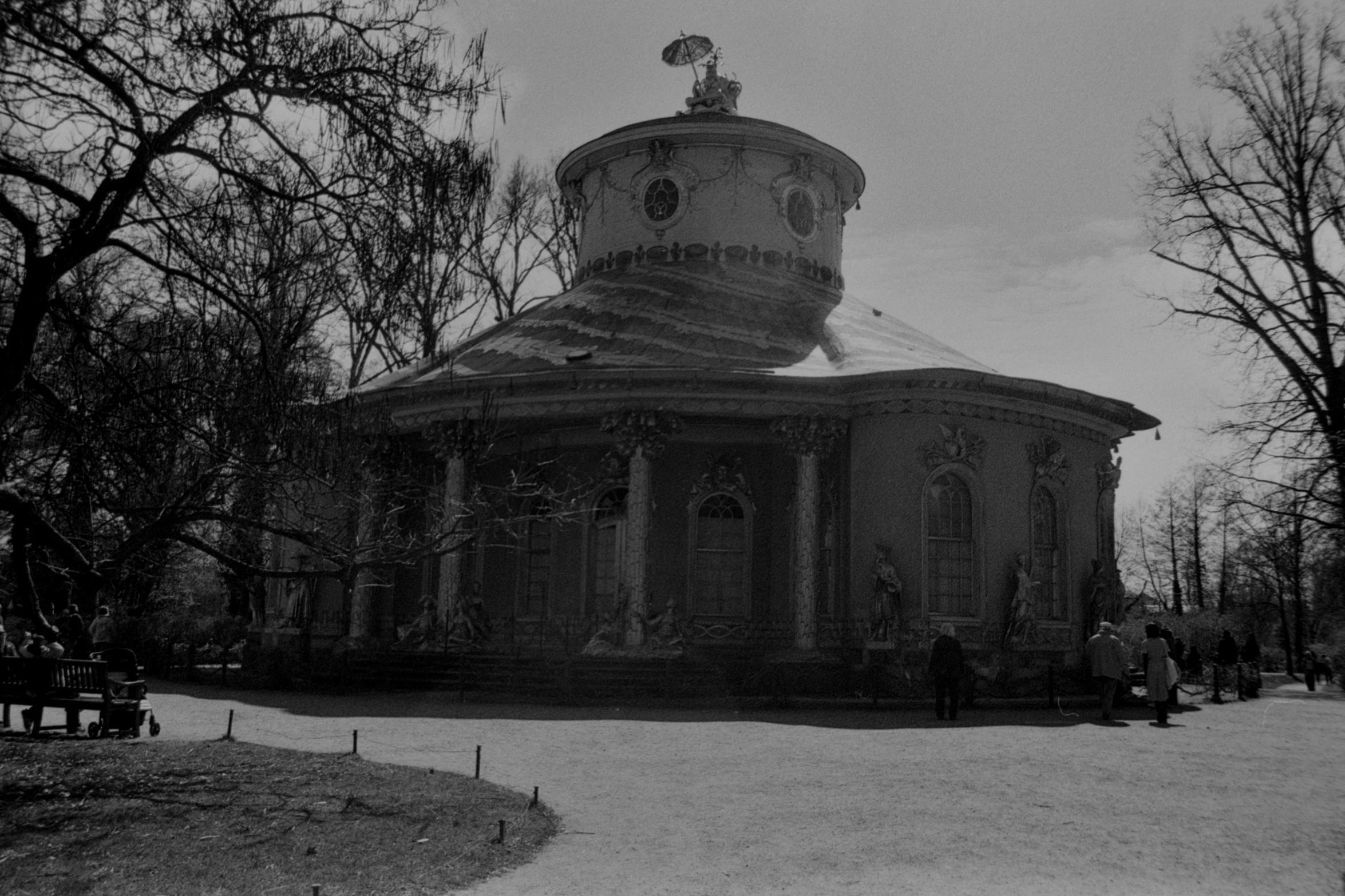 a building with a steeple sitting next to a park