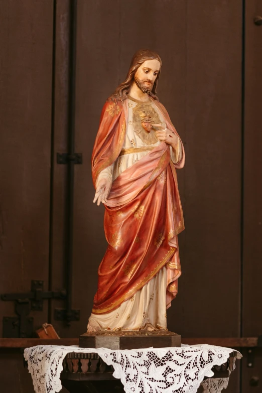 a jesus statue that has been placed on a white table