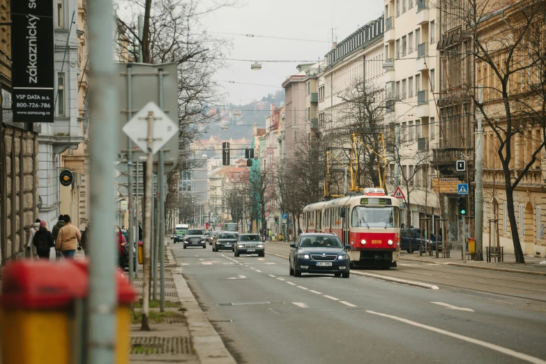 a city street with cars driving down it