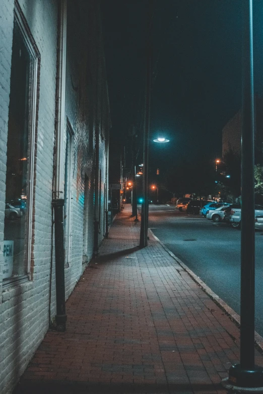 a lone person standing alone in an empty street at night