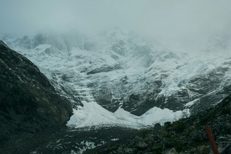 the view of a snowy mountain from below