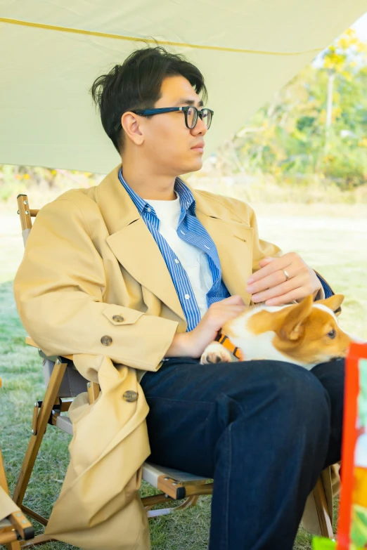 a man sits on a chair with a dog