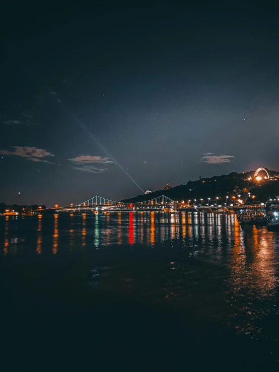 the full moon rises above a very dark city