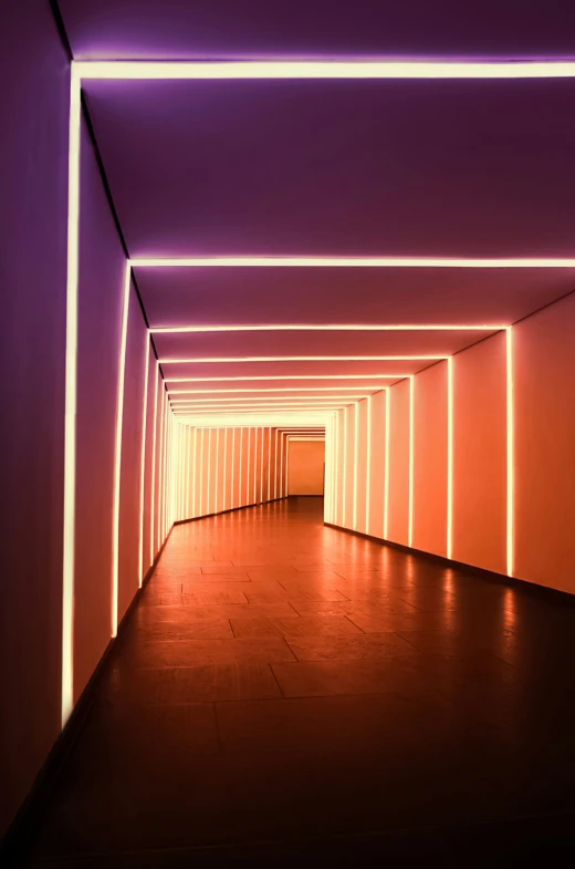 an empty hallway with neon lights inside