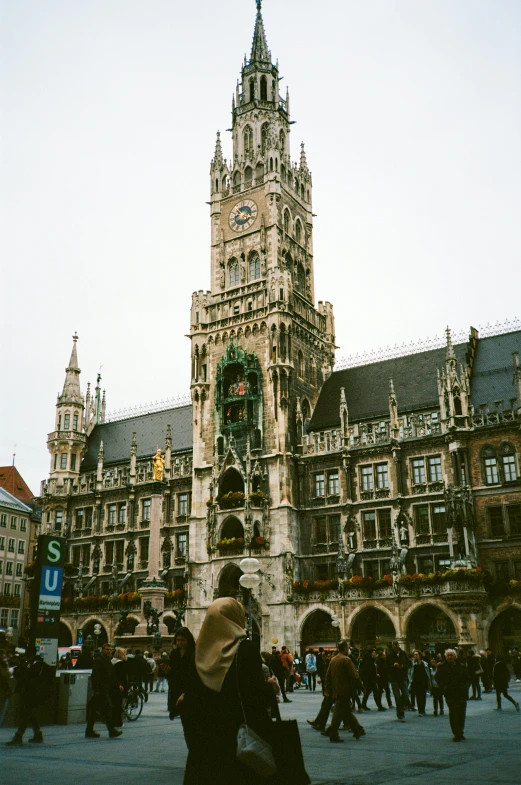 people on street near buildings and large clock tower