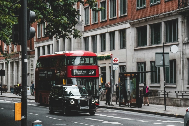 the bus is driving down the busy city street