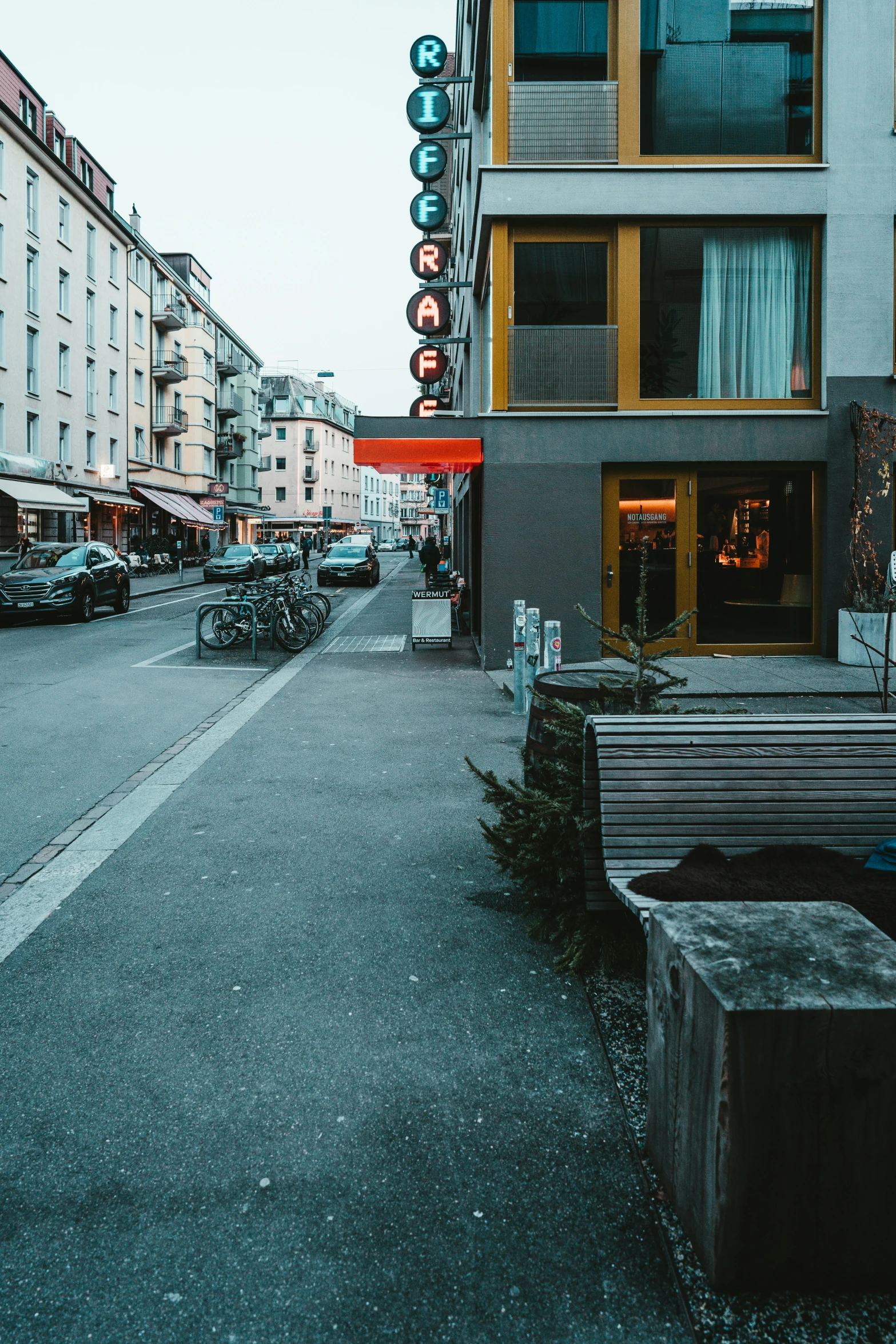 there are many parked motorcycles in front of the buildings