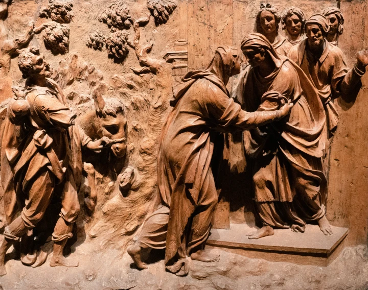 a carving depicting four people near one another