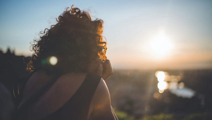 a person with her hair in the sun