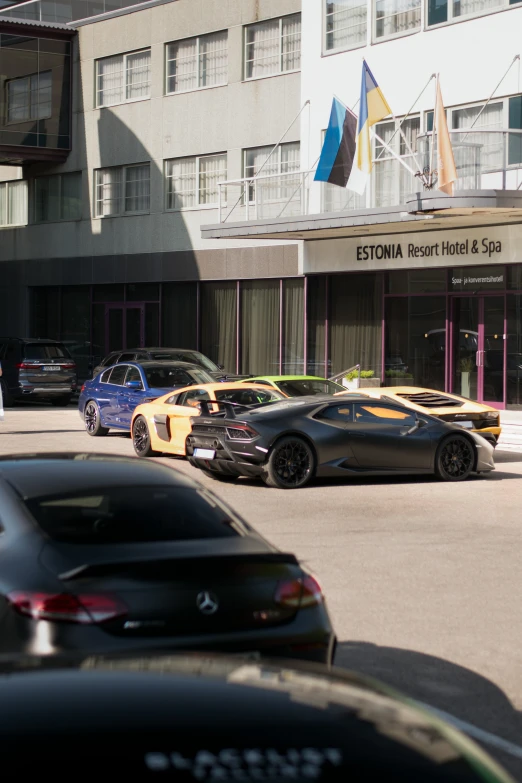 several parked cars are sitting in a street