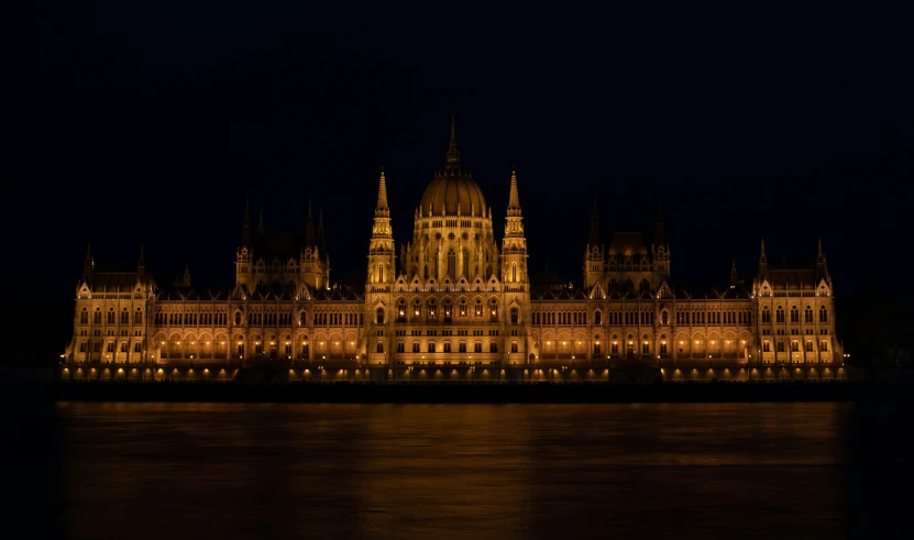 night time view of an ornate palace with large clocks