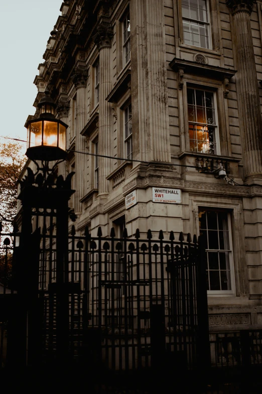 this old building is very well maintained by the iron fence