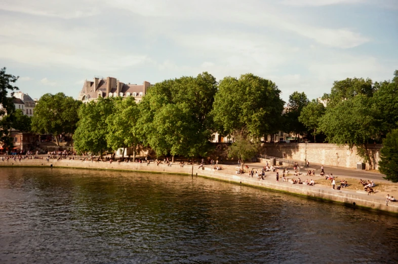 some people are swimming in the water by the waterfront