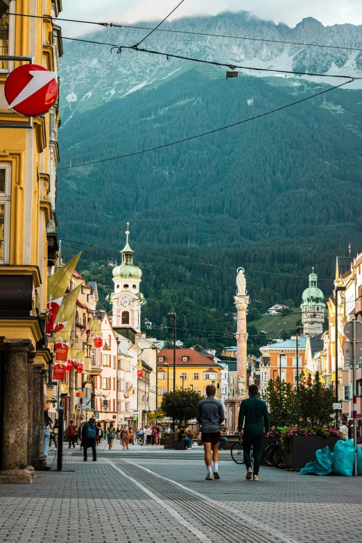 people walking around on a city street in mountains