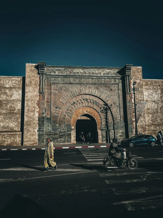 a person walking towards an entrance to an old building