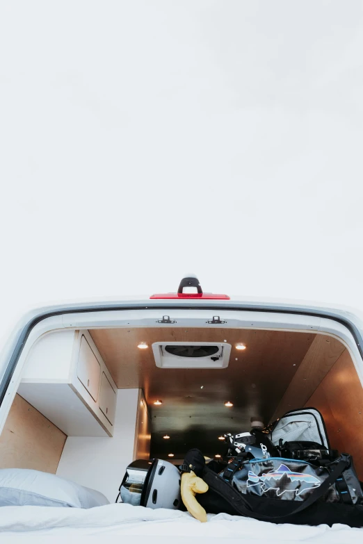 the inside view of a van with a lot of luggage in it