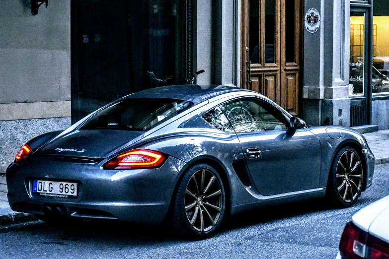 a sleek silver porsche sports car parked on the street