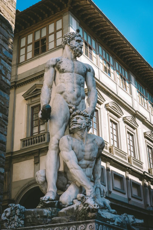 a large statue is next to the building