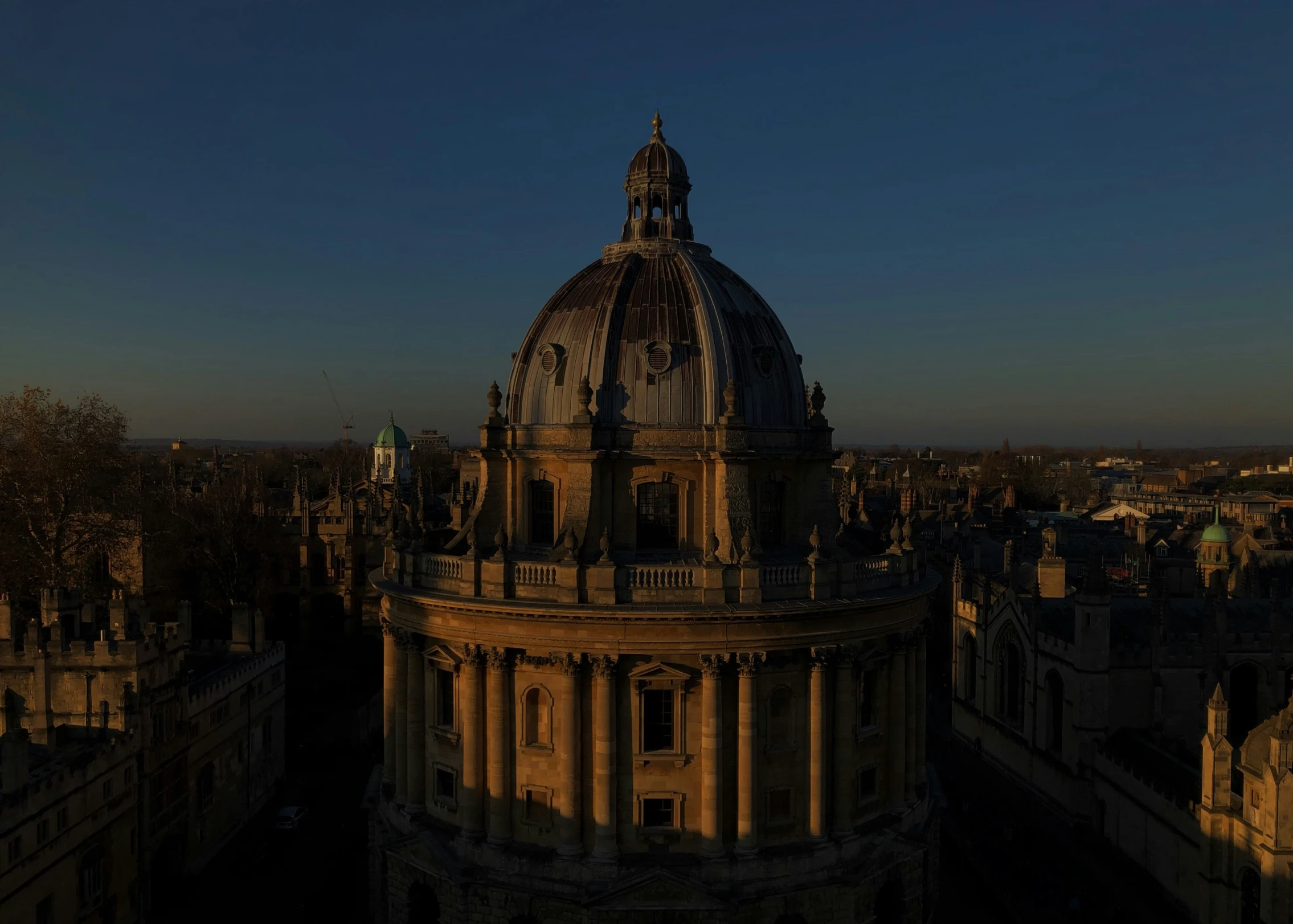 the dome is above some buildings with towers