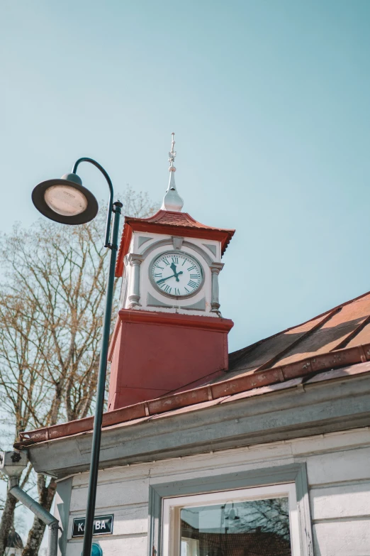 a white clock mounted on the side of a building