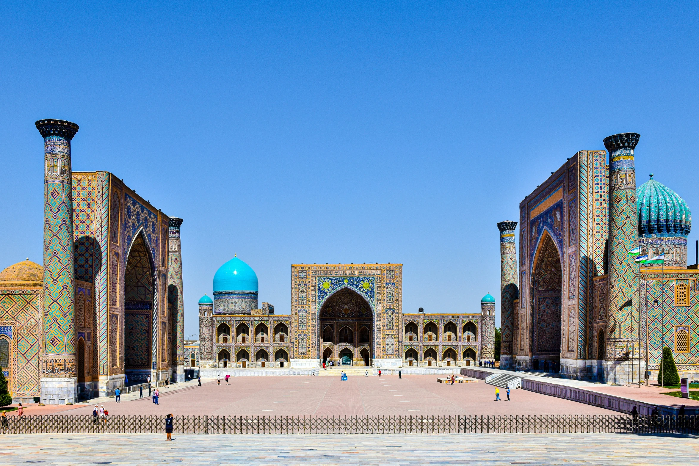 people stand around and look at some elaborate buildings