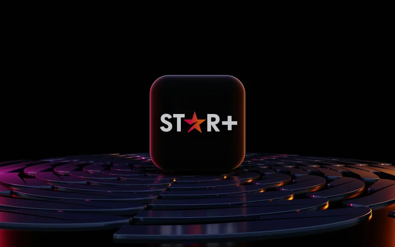 the star logo on top of a table with a laptop keyboard