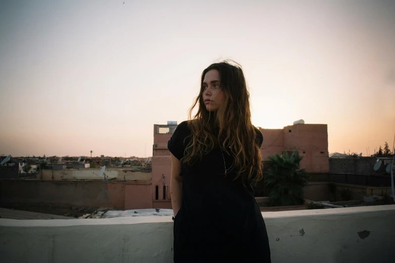 young woman with long dark hair staring to the camera