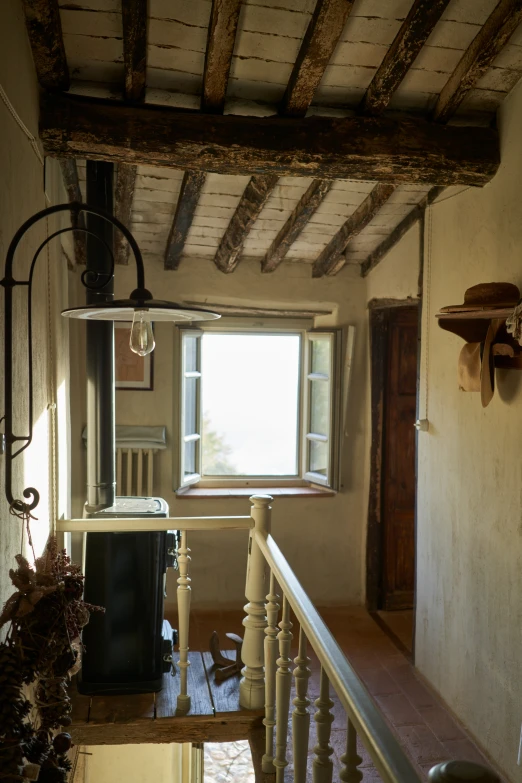 view of stairwell from inside a house with large window