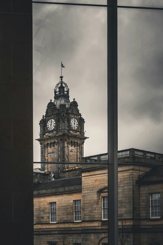 a tall building with a clock tower near other buildings