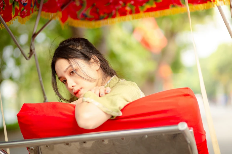 a little girl is in a swing chair