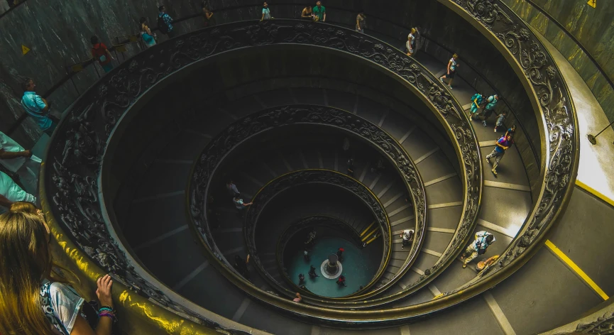 many people on stairs with a spiral stair