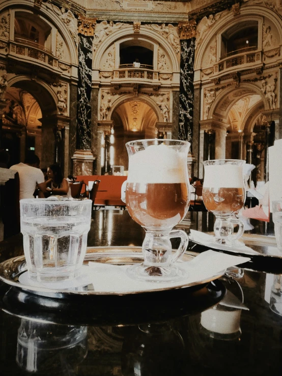 a black table topped with three glasses and plates