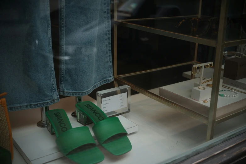 green shoes sit in front of an empty display